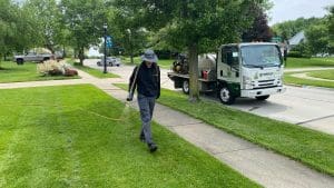 Greener Grass expert engaged in precise weed control work in Wadsworth, OH, exemplifying the company's commitment to maintaining weed-free lawns and enhancing the overall beauty of the Wadsworth community's outdoor spaces.