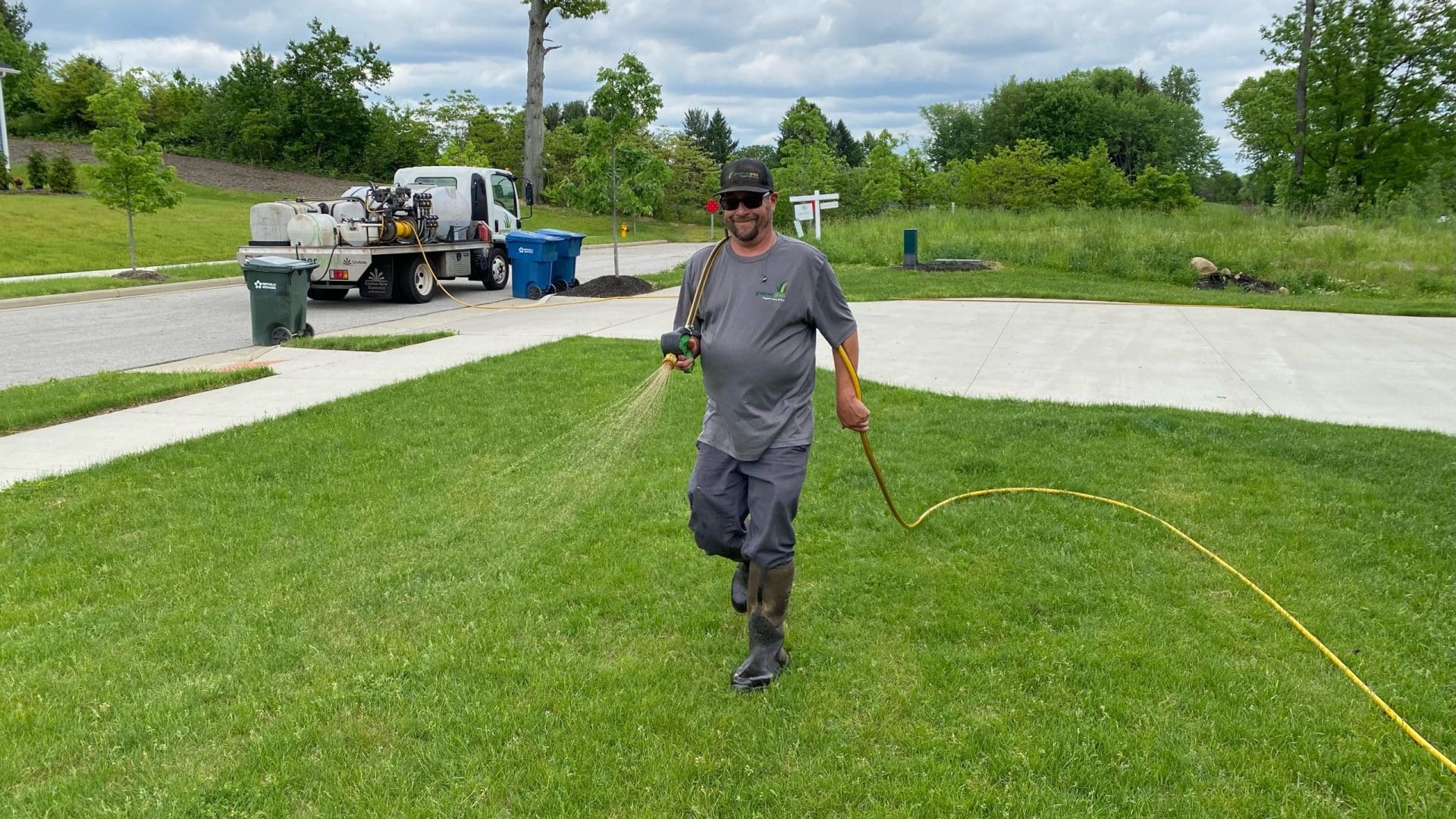 Greener Grass professional diligently spraying for weeds in Massillon, OH, showcasing the company's commitment to precise and effective weed control services for the Massillon community, ensuring lush and pristine lawns.